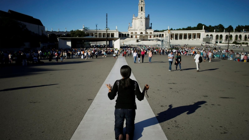 A pilgrim prays near the Marian shrine of Fatima in central Portugal May 12, 2019. Pilgrims to Fatima today will find a beautiful campus of churches, monuments, plazas and other buildings that have been built up around the site where the Blessed Virgin Mary appeared in 1917. (OSV News photo/Pedro Nunes, Reuters)