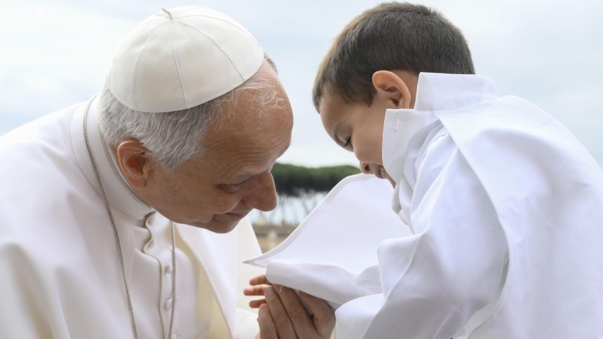 Pope Leo XIV greets a young boy from the popemobile in St. Peter's Square at the Vatican before leading his weekly general audience May 6, 2026. (CNS photo/Vatican Media)