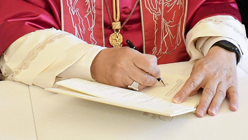 Pope Leo XIV signs his first apostolic exhortation, "Dilexi Te" ("I Have Loved You"), in the library of the Apostolic Palace at the Vatican Oct. 4, 2025, the feast of St. Francis of Assisi. His first encyclical, "Magnifica Humanitas," will be published May 25, 2026, addressing artificial intelligence and the protection of human dignity, the Vatican announced May 18, 2026. (OSV News photo/Vatican Media/CPP)