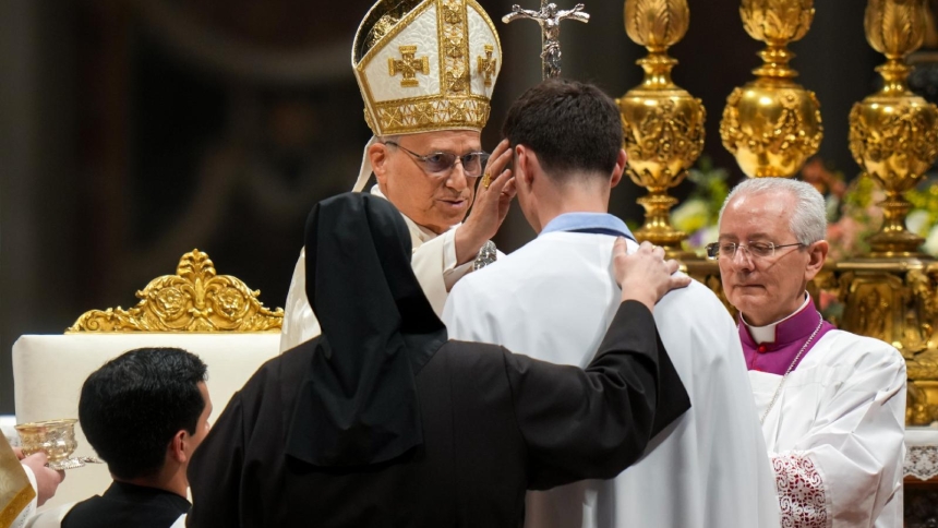 Pope Leo XIV confirms a man he baptized during the Easter Vigil in St. Peter's Basilica at the Vatican April 4, 2026. (CNS photo/Lola Gomez)