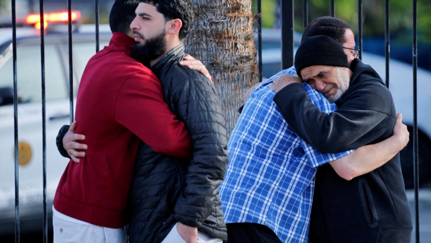 Men embrace outside the Islamic Center in San Diego May 19, 2026, after a deadly shooting the previous day. One of the three people killed by two teen shooters at a San Diego mosque was a beloved security guard who acted quickly to prevent more deaths, authorities and community members said. The two teenage gunmen killed themselves a few blocks away -- in an attack police are investigating as a hate crime. (OSV News photo/Mike Blake, Reuters)