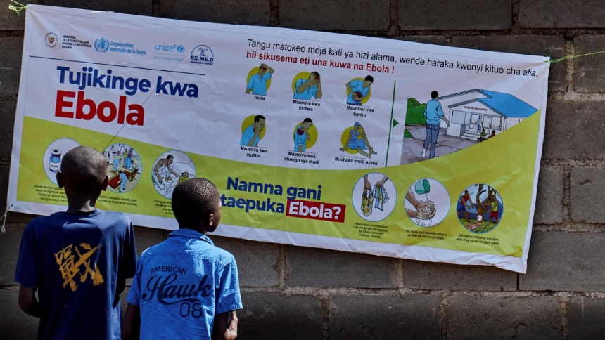 Congolese children read an advocacy poster in Bunia, Congo, May 20, 2026, as aid agencies intensify efforts to contain a new Ebola outbreak caused by the Bundibugyo strain outbreak. (OSV News photo/Gradel Muyisa Mumbere, Reuters)