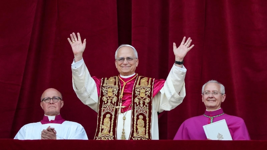 Pope Leo XIV waves to the crowds in St. Peter's Square at the Vatican after his election as pope May 8, 2025. (CNS photo/Lola Gomez)