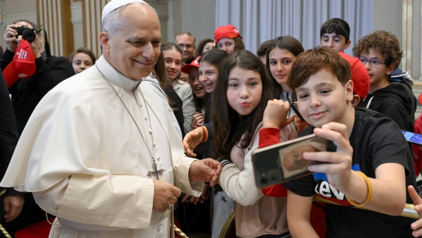 Pope Leo XIV poses for a selfie as he meets May 16, 2026, with young Catholics from the Italian Archdiocese of Genoa at the Vatican who are preparing to receive the sacrament of confirmation. (OSV News photo/Simone Risoluti, Vatican Media)