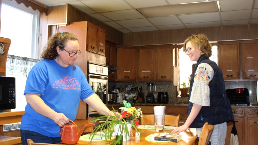 Kristy Olsen, community resource supervisor, and Jennie Weer, donor relations officer, water the plants and check the supplies in the kitchen of the former convent at Sojourner Truth House in Gary, which has been converted into a transitional housing center for young women ages 18-24. The Poor Handmaids of Jesus Christ, sponsors of STH, has donated the convent, and a former orphanage in East Chicago, to the women’s resource center. (Marlene A. Zloza photo)