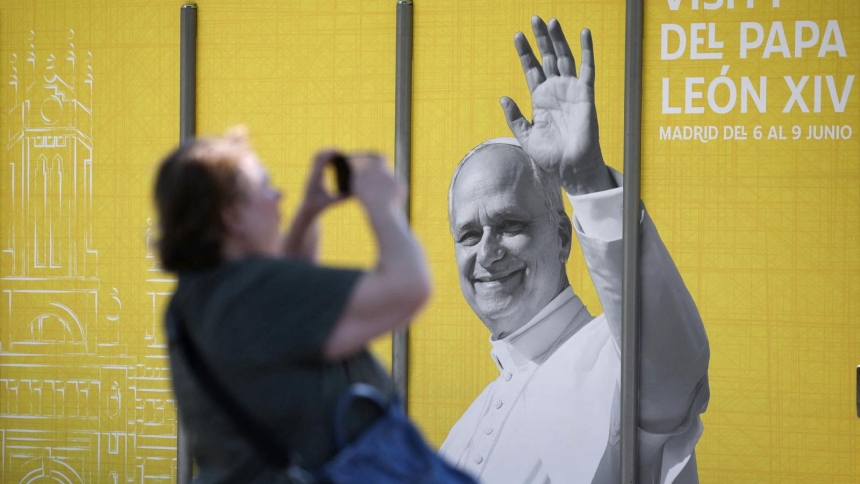 A woman in Madrid takes a picture of a poster of Pope Leo XIV May 28, 2026, ahead of the pontiff's June 6-12 apostolic visit to Spain. (OSV News photo/Kacper Pempel, Reuters)
