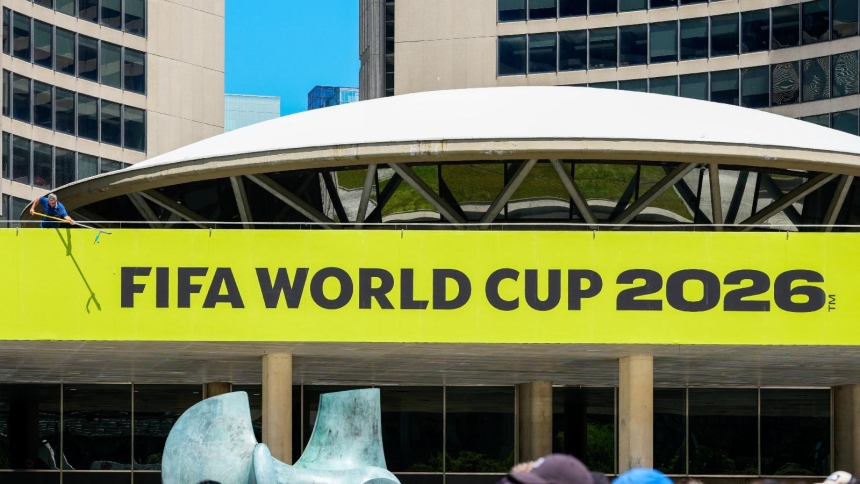 A Toronto city worker cleans a sign outside of City Hall during the 2026 FIFA World Cup Trophy Tour by Coca-Cola at Nathan Phillips Square May 25, 2026. The U.S. Conference of Catholic Bishops in partnership with the Pennsylvania Catholic Conference and New Jersey Catholic Conference held an event to explore the intersection of human trafficking and major sporting events as the nation prepares to host the 2026 World Cup. (OSV News photo/Kevin Sousa-Imagn Images via Reuters) EDITORS: MANDATORY CREDIT
