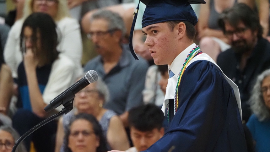 Marquette Catholic High School valedictorian Anthony Pecoski gives an emotional speech during commencement ceremony in the Scholl Center on June 10. (Deacon Bob Wellinski photo)