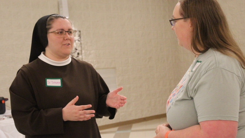 Sister Solana Voegsel, OSF, chats with Andrea Fortier, of Merrillville, before the Sister of St. Francis of Perpetual Adoration presented a talk on the Sacred Heart of Jesus on June 10 at Fortier’s parish, Our Lady Queen of Martyrs South Campus in Merrillville. She urged the young people to find time for Eucharistic Adoration to grow closer to Jesus. (Marlene A. Zloza photo)