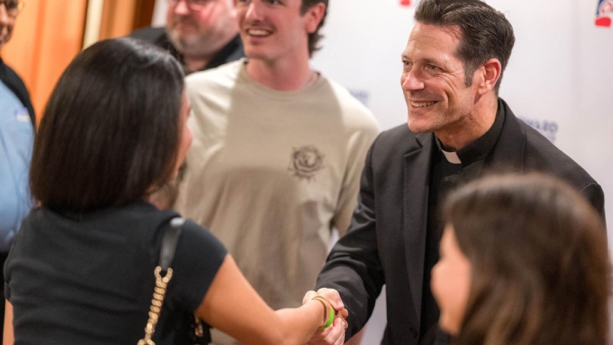 Father Mike Schmitz, a diocesan priest in the Diocese of Duluth, Minn., and a popular priest on social media,, meets with young adults from St. David Catholic Church in Davie, Fla., at the Broward Center for the Performing Arts in downtown Fort Lauderdale, Fla., May 20, 2026. Father Schmitz spoke in three Florida cities that month as part of his Parables Tour. His last tour date is July 20 in Dublin. (OSV News photo/Tom Tracy)