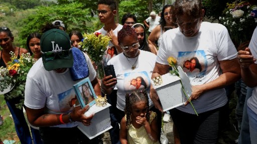 Juana Aiskel Fumero, mother of Ashley Martinez, 29, and grandmother of Kalani Martinez, 2, who were killed in the June 24, 2026, earthquakes, carries Kalani's ashes, while Zuleiry Martinez carries Ashley's ashes, to be buried at Tarmas cemetery, in La Guaira, Venezuela, July 15. Two catastrophic earthquakes hit Venezuela in quick succession, leaving at least 5,000 dead with thousands still missing. (OSV News photo/Pablo Sanhueza, Reuters)