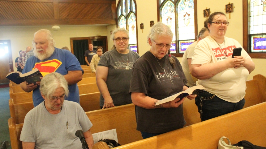 A family of parishioners from Knox, led by hymn leader John Kleist (standing at left), opened Mass with  “Amazing Grace” on July 25 at Holy Cross in Hamlet. Father Anthony Spanley and his congregation welcomed Bishop Robert J. McClory as celebrant, with Father Spanley assisting. (Marlene A. Zloza photo)