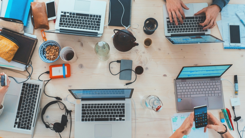 View of a table with laptops and devices