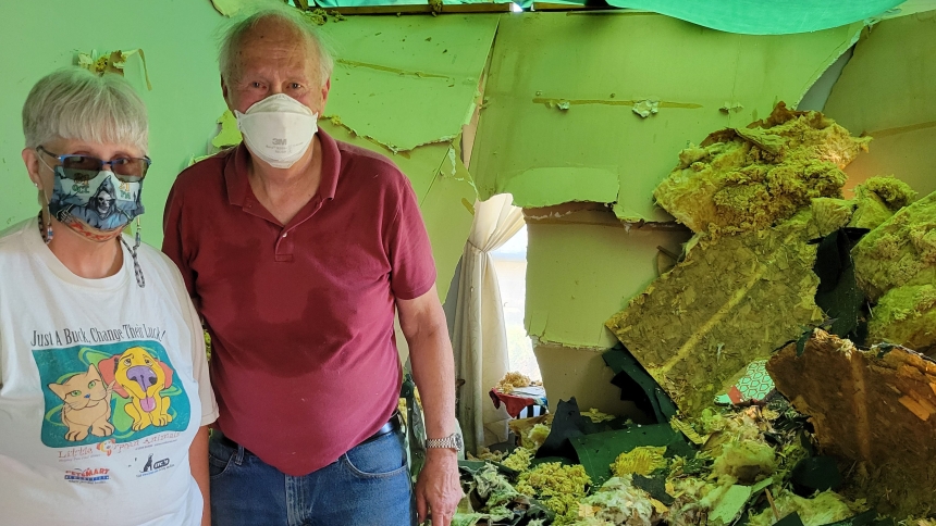 Homeowner Patricia Howe, a parishioner at St. Michael the Archangel in Schererville,  and Jim Koeling from Rebuilding Hope stand among the debris of her home, damaged by the tornado that swept through Merrillville. (Provided photo)