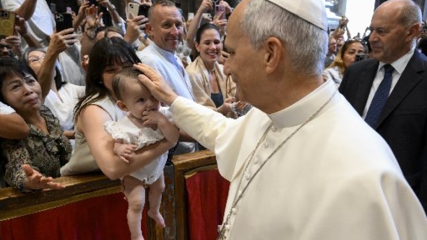 Pope Leo XIV greets a baby and family before his weekly general audience in St. Peter’s Basilica at the Vatican Aug. 12, 2026. (CNS photo/Vatican Media)