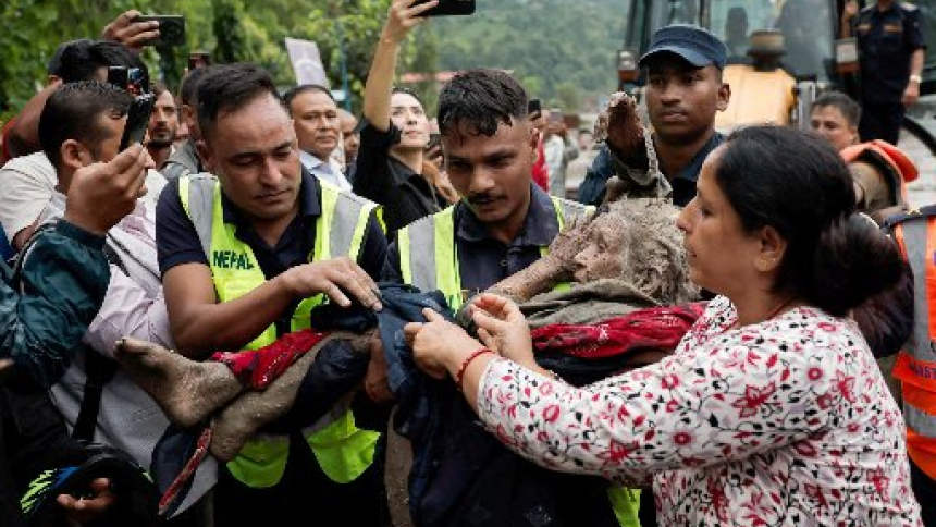 Police officers carry an elderly survivor to a safer place at Trishuli in Nepal's Nuwakot district Aug. 27, 2026, following devastating floods. Massive flash floods in a border area of Nepal and China killed at least 160 people and left hundreds of tourists, workers and others missing after suddenly sweeping through communities and halting travel in some areas Aug. 26. Experts said a glacial collapse caused the disaster in the warming Himalayan region. (OSV News photo/Navesh Chitrakar, Reuters)
