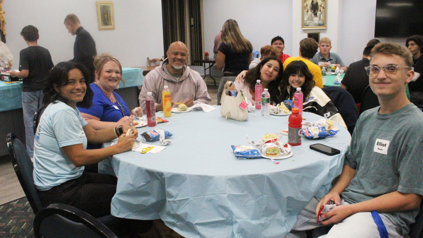 Sandwiches and snacks were devoured by young people during a social hour after the “Emmaus Youth Encounter: Hearts on Fire! Walking with Purpose” program on Aug. 21 at St. Paul in Valparaiso. Spending time with keynote speaker Father Agustino Torres, CFR (third from left) are (from left) Vanessa Breshock, chaperone Heather Sandilla, Father Agustino, Victoria Ramirez, Camryn Latham and Elliott Poole, all from Crown Point. (Marlene A. Zloza photo)