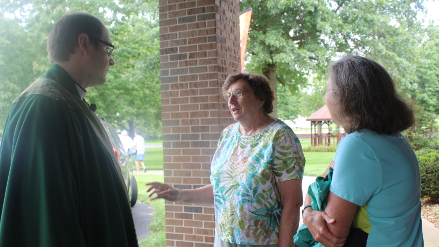 Holy Spirit in Winfield held just one Mass on Aug. 16 at its worship site, St. Helen in Hebron, to welcome new administrator Father Steven Caraher (left), who greets Carol Lee and Judy Fidcher outside the church. The Annual Parish Mass and Picnic drew a large congregation as it also incorporated an official welcome for Father Caraher, who previously served as associate pastor at Our Lady, Queen of Martyrs in Merrillville, another combined parish, following his ordination to the priesthood in 2024. (Marlene 
