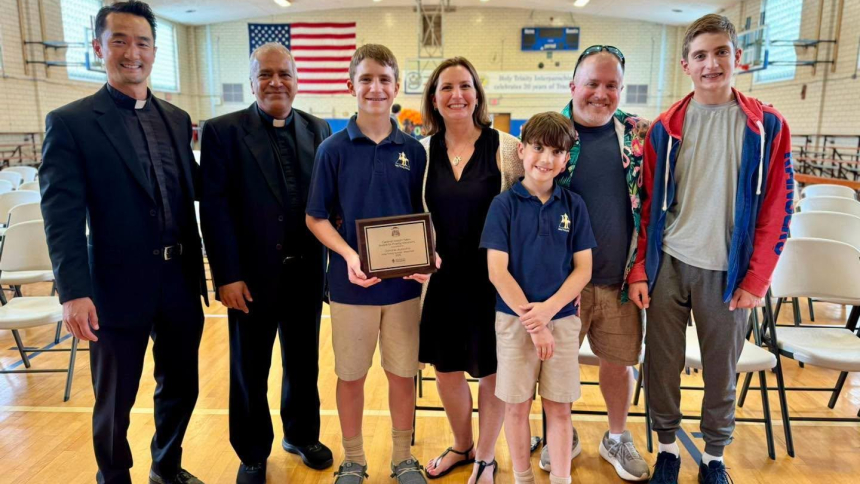 Father Patrick Seo, left, director of priestly vocations in the Archdiocese of Newark, N.J., joins Father George Joseph, pastor of Holy Trinity Parish in Westfield, Dominic Auricchio, Maria Auricchio, Maximo Auricchio, Neal Auricchio and Vincenzo Auricchio at a ceremony this summer to present Dominic, 13, a plaque and $1,500 for his first-place essay in the archdiocese’s 2026 Cardinal Joseph Tobin Essay and Video Contest. (OSV News photo/courtesy Archdiocese of Newark)