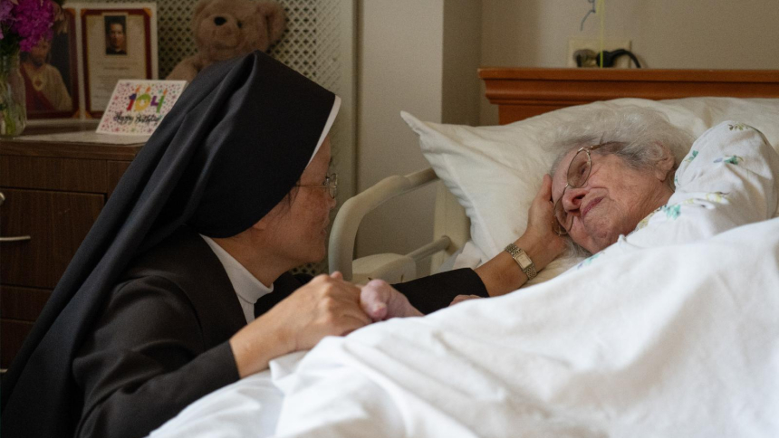 A Carmelite Sister comforts a resident Aug. 21, 2026, at St. Patrick’s Residence in Naperville, Ill. Cardinal Blase J. Cupich of Chicago, the Carmelite Sisters for the Aged and Infirm and the Chicago Province of the Little Sisters of the Poor, and an Illinois pharmacist sued Illinois Sept. 3 over the state's physician-assisted suicide law, which permits physicians to aid terminally ill adults in dying by suicide. (OSV News photo/courtesy Becket)