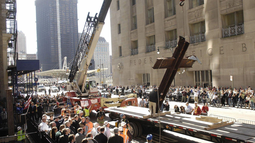Construction workers Oct. 5, 2006, remove a 20-foot cross formed by steel beams that was recovered from the rubble after the Sept. 11, 2001, attacks brought down the World Trade Center in New York. Twenty-five years after the 9/11 terrorism attacks that claimed the lives of nearly 3,000 people, Catholic family members who lost loved ones that day have credited their faith with getting through the losses. (OSV News photo/Chip East, Reuters)