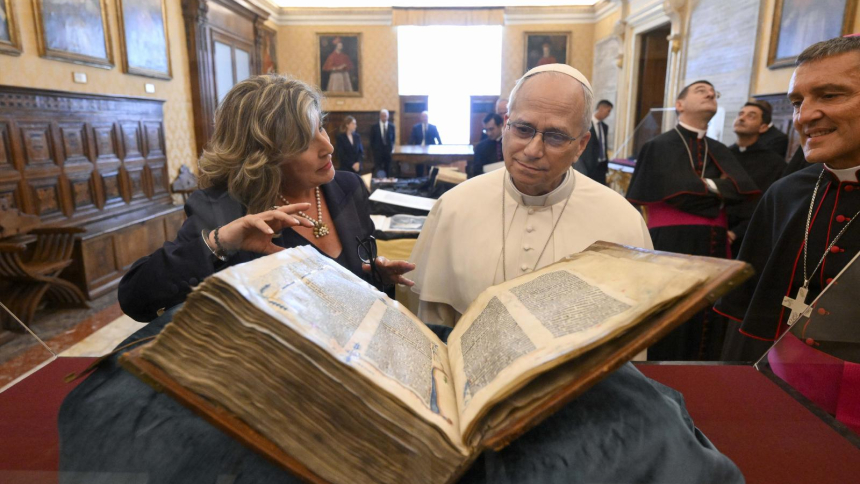 Pope Leo XIV looks at a book as he attends the inauguration of the exhibition "AQVA. Catastrophe and Wonder" at the Vatican Library Sept. 14, 2026. The exhibition is the opening chapter of a five-year cycle exploring water as both a life-giving and destructive force. (CNS photo/Simone Risoluti, Vatican Media)