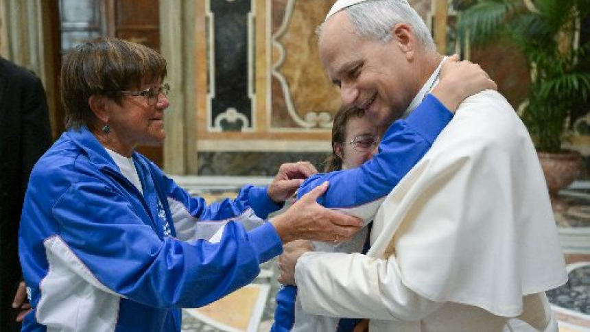 Pope Leo XIV is embraced by a member of a delegation from the Special Olympics during a private audience at the Vatican Sept. 19, 2026. (OSV News photo/Simone Risoluti Vatican Media)
