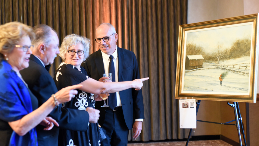 Sandy and Joe Szczerbowski and Cindy and Philip Baumeister of Holy Spirit Parish view art works at the Black Tie White Collar gala on Sept. 18 at Avalon Manor Banquet Center in Merrillville. Hundreds of guests gathered for introductions, games, dining and live and silent auctions at the tenth annual event to benefit priestly vocations. (Anthony D. Alonzo photo)
