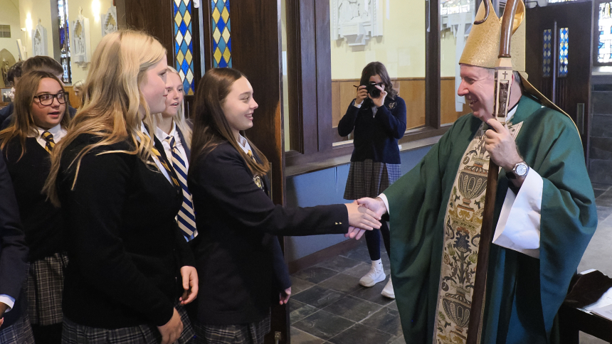 Bishop Robert J. McClory greets students and teachers Marquette Catholic High School’s Back to School Mass at St. Mary the Immaculate Conception Church . (Deacon Bob Wellinski photo)