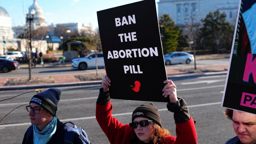 Demonstrators hold signs during a protest outside the U.S. Department of Health and Human Services in Washington Jan. 22, 2026, calling on President Donald Trump's administration to ban the abortion pill. In a Sept. 29, statement, Bishop Daniel E. Thomas of Toledo, Ohio, chairman of the U.S. bishops' pro-life committee, urged the faithful to mark Respect Life Month with prayer for an end to abortion and action to stop use of the abortion pill. (OSV News photo/Aaron Schwartz, Reuters)