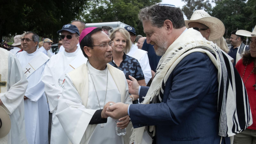 San Diego Bishop Michael M. Pham shakes hands with Rabbi Mike Rothbaum Sept. 27, 2026, after the bishop led more than 4,000 people in a procession on the World Day of Migrants and Refugees. The event in Balboa Park was held to support immigrants and to proclaim that "All Are Sacred." Dozens of other faith leaders participated in the procession. (OSV News photo/David Maung)