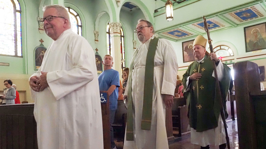 Brother Shaun Gray, Father Walter Rakoczy, and Bishop Robert J. McClory process in at St. Stanislaus Kostka Church. (Mary Wellinski photo) 