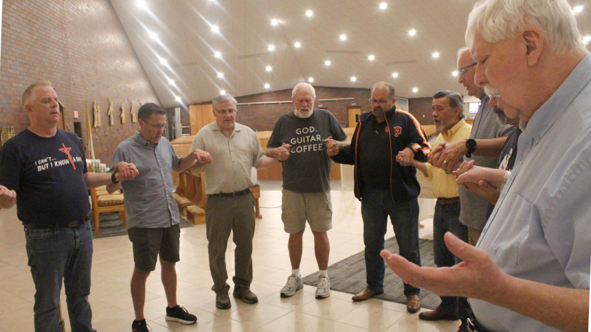 The Men's Cursillo Team closes every meeting by sharing a moment of praise and thanksgiving to God with each other. Forming a chapel circle in front of the altar at Nativity of Our Savior on Oct. 11 are (from left) Jon McGinty, Darren Farha, John Stahura, John Cox, Rob Pastore, Louie Gonzalez, Phil Page, Jose Flores (obscured) and Father Thomas Mischler. (Marlene A. Zloza photo)