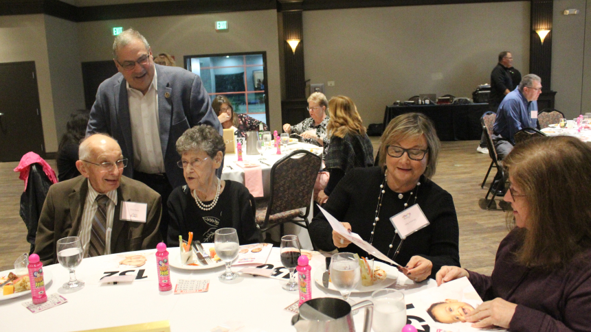 Enjoying the Fourth Annual Luxury Bingo fundraiser benefitting the Women's Care Center in Merrillville at a table sponsored by St. Thomas More in Munster are (from left) Tony Kaim of All Souls in Lansing, Ill., Dan Dernulc (standing) of Our Lady of Grace in Highland, Julie Dernulc of Schererville and Our Lady of Grace, Monica Sajn of St. Thomas More, and Ginny Miceli of Munster, who worships at the Carmelite Shrine in Munster. (Marlene A. Zloza photo)