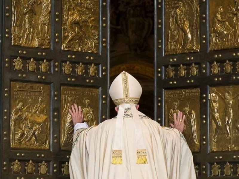 Pope Francis pushing holy door open