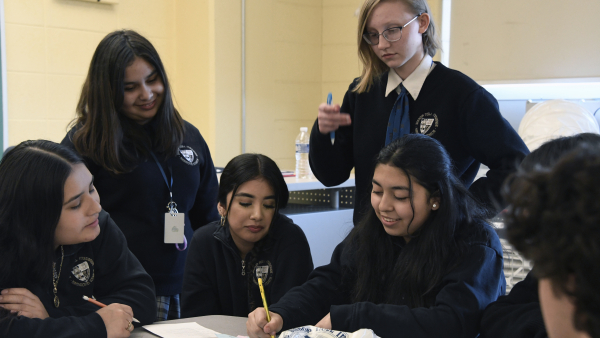 Bishop Noll Institute sophomores including Julissa Muniz (second from left), Cara Van Till (top) and Jara Zamora (right) discuss their feelings of relating to the principles of the pastoral letter "We Proclaim Jesus as Lord!" at the Symposium on Youth Evangelization in a classroom at the Hammond school on April 26. 